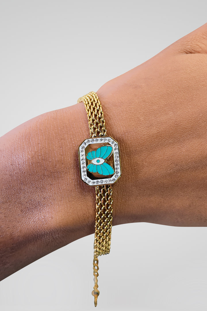 MULHER-PULSEIRA DOURADA COM DETALHE AZUL NOVA